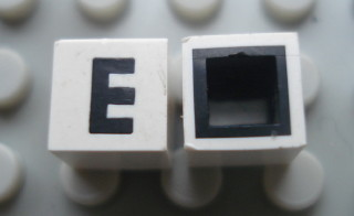 Modulex, Tile 1 x 1 with Black 'E' Pattern (with black lining on sides only)