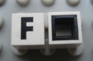 Modulex, Tile 1 x 1 with Black 'F' Pattern (with black lining on sides only)