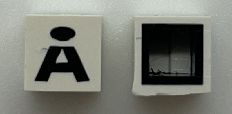 Modulex, Tile 1 x 1 with Black 'Å' Pattern (with black lining on sides only)