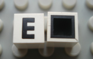 Modulex, Tile 1 x 1 with Black 'E' Pattern (with black lining on top and sides)