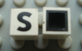 Modulex, Tile 1 x 1 with Black 'S' Pattern (with black lining on top and sides)