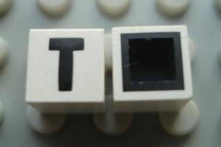 Modulex, Tile 1 x 1 with Black 'T' Pattern (with black lining on top and sides)