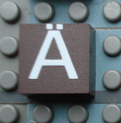 Modulex, Tile 2 x 2 (no Internal Supports) with White Capital Letter A with Diaeresis (Ä) Pattern