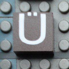 Modulex, Tile 2 x 2 (no Internal Supports) with White Capital Letter U with Diaeresis (Ü) Pattern