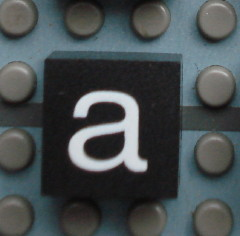 Modulex, Tile 2 x 2 (no Internal Supports) with White Lowercase Letter a Pattern