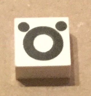 Modulex, Tile 2 x 2 (no Internal Supports) with Black Lowercase Letter o with Diaeresis (ö) Pattern