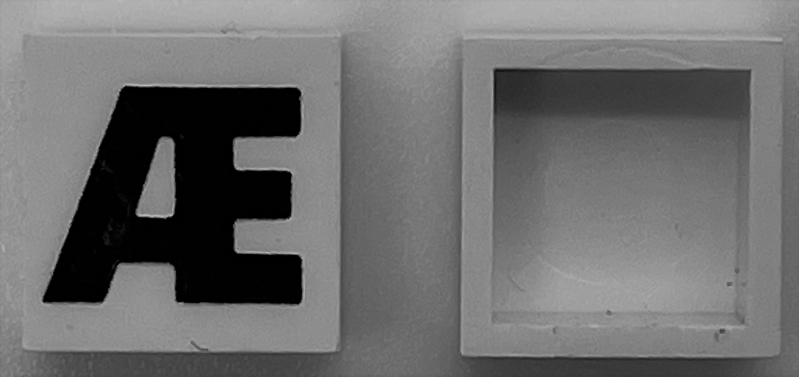 Modulex, Tile 2 x 2 (no Internal Supports) with Black Capital Letter Æ Pattern