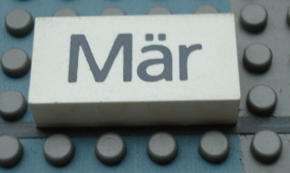 Modulex, Tile 2 x 4 with Dark Gray Month 'Mär' Pattern