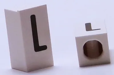 Tile, Modified 1 x 2 x 5/6 Stud Hole in End with Black Capital Letter L Pattern