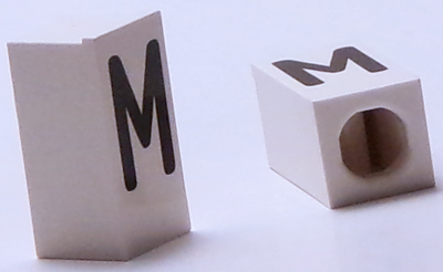 Tile, Modified 1 x 2 x 5/6 Stud Hole in End with Black Capital Letter M Pattern