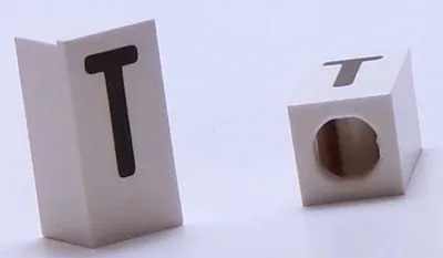 Tile, Modified 1 x 2 x 5/6 Stud Hole in End with Black Capital Letter T Pattern