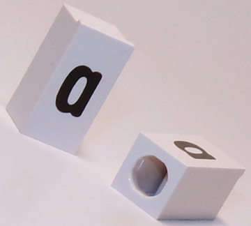 Tile, Modified 1 x 2 x 5/6 Stud Hole in End with Black Lowercase Letter a Pattern