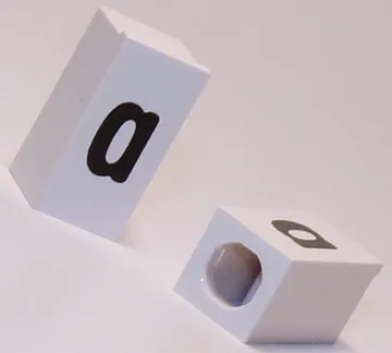 Tile, Modified 1 x 2 x 5/6 Stud Hole in End with Black Lowercase Letter a Pattern