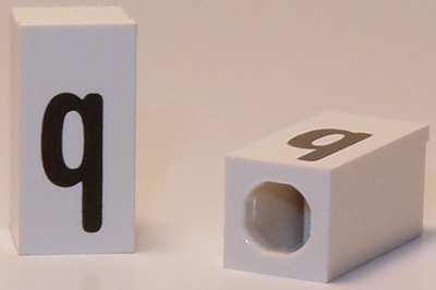 Tile, Modified 1 x 2 x 5/6 Stud Hole in End with Black Lowercase Letter q Pattern