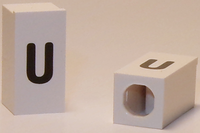 Tile, Modified 1 x 2 x 5/6 Stud Hole in End with Black Lowercase Letter u Pattern