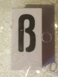 Tile, Modified 1 x 2 x 5/6 Stud Hole in End with Black Lowercase Letter Sharp s (ß) Pattern