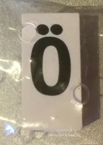 Tile, Modified 1 x 2 x 5/6 Stud Hole in End with Black Capital Letter O with Diaeresis (Ö) Pattern