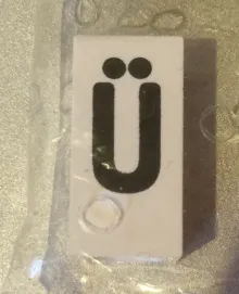 Tile, Modified 1 x 2 x 5/6 Stud Hole in End with Black Capital Letter U with Diaeresis (Ü) Pattern
