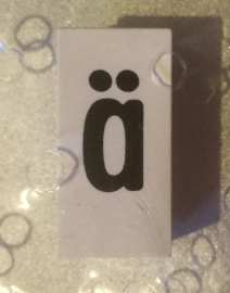 Tile, Modified 1 x 2 x 5/6 Stud Hole in End with Black Lowercase Letter a with Diaeresis (ä) Pattern