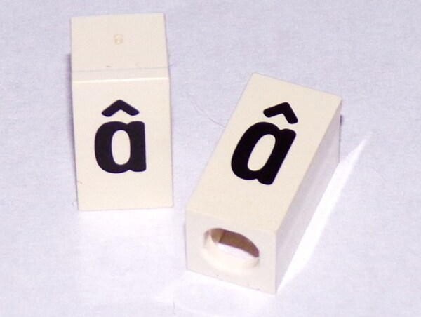 Tile, Modified 1 x 2 x 5/6 Stud Hole in End with Black Lowercase Letter a with Circumflex (â) Pattern