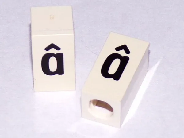 Tile, Modified 1 x 2 x 5/6 Stud Hole in End with Black Lowercase Letter a with Circumflex (â) Pattern