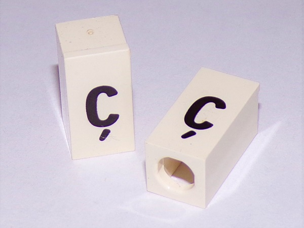 Tile, Modified 1 x 2 x 5/6 Stud Hole in End with Black Lowercase Letter c with Cedilla (ç) Pattern