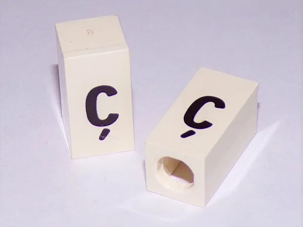 Tile, Modified 1 x 2 x 5/6 Stud Hole in End with Black Lowercase Letter c with Cedilla (ç) Pattern