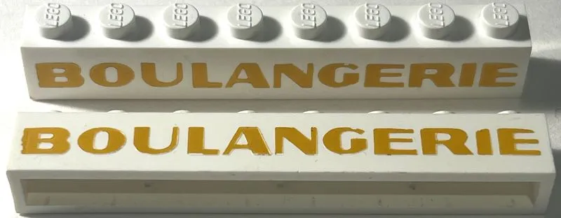 Brick 1 x 8 without Bottom Tubes with Cross Side Supports with Light Gold 'BOULANGERIE' Sans-Serif Bold Pattern