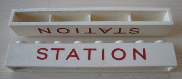 Brick 1 x 8 without Bottom Tubes with Cross Side Supports with Red 'STATION' Thin Large Pattern