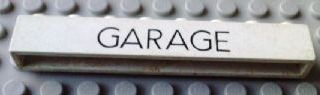 Brick 1 x 8 without Bottom Tubes with Cross Side Supports with Black 'GARAGE' Thin (Letters Close) Pattern