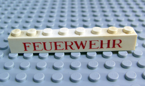 Brick 1 x 8 without Bottom Tubes with Cross Side Supports with Red 'FEUERWEHR' Pattern