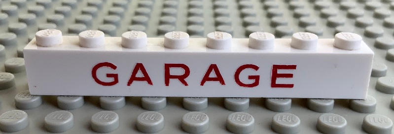 Brick 1 x 8 without Bottom Tubes with Cross Side Supports with Red 'GARAGE' Sans-Serif Medium Pattern