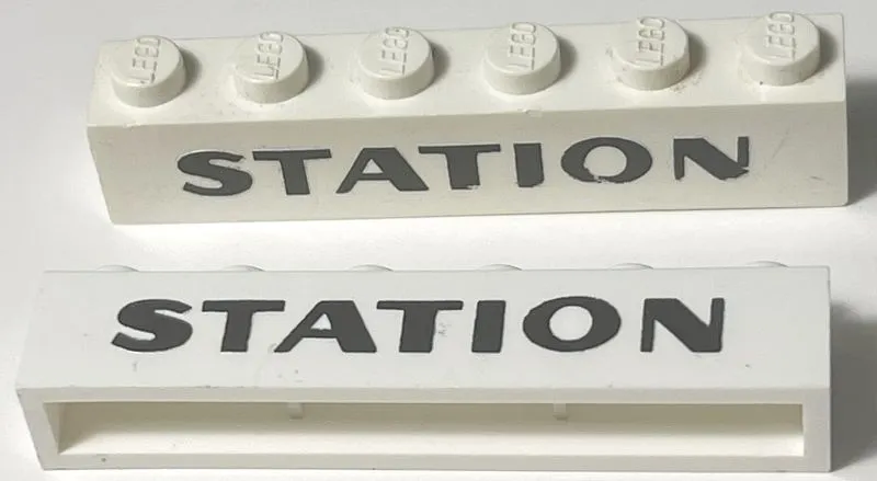 Brick 1 x 6 without Bottom Tubes with Cross Side Supports with Black 'STATION' Sans-Serif Bold Pattern