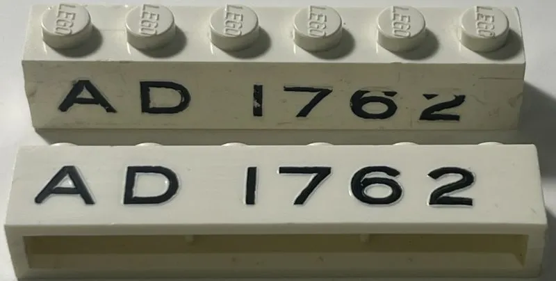 Brick 1 x 6 without Bottom Tubes with Cross Side Supports with Black 'AD 1762' Pattern