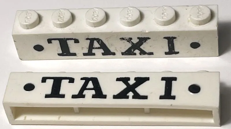 Brick 1 x 6 without Bottom Tubes with Cross Side Supports with Black 'TAXI' Serif Bold Large and Dots Pattern