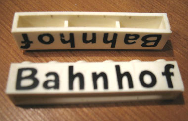 Brick 1 x 6 without Bottom Tubes with Cross Side Supports with Black 'Bahnhof' Pattern