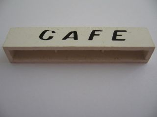 Brick 1 x 6 without Bottom Tubes with Cross Side Supports with Black 'Cafe' Italics Pattern