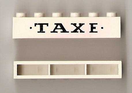 Brick 1 x 6 without Bottom Tubes with Cross Side Supports with Black 'TAXE' and Dots Small Pattern