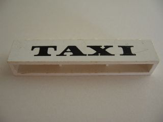 Brick 1 x 6 without Bottom Tubes with Cross Side Supports with Black 'TAXI' Thick Pattern