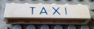 Brick 1 x 6 without Bottom Tubes with Cross Side Supports with Blue 'TAXI' Thin Letters Pattern
