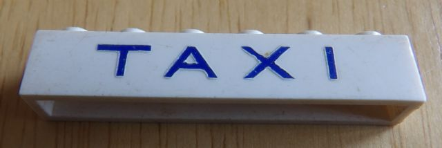 Brick 1 x 6 without Bottom Tubes with Cross Side Supports with Blue 'TAXI' Thin Letters Wide Pattern
