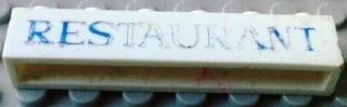 Brick 1 x 6 without Bottom Tubes with Cross Side Supports with Blue 'RESTAURANT' Serif Pattern