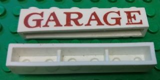 Brick 1 x 6 without Bottom Tubes with Cross Side Supports with Red 'GARAGE' Serif Pattern